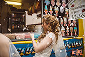 Bridesmaids enjoy ice creams amidst a shower of rose petals at the wedding.