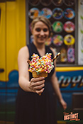 A girl enjoys the delicious ice cream cone with toppings, served from Mister Nice Cream's ice cream van.